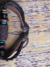 Tribal pendant, brown string, Leather & beaded earth colours adjustable bracelet (one love)